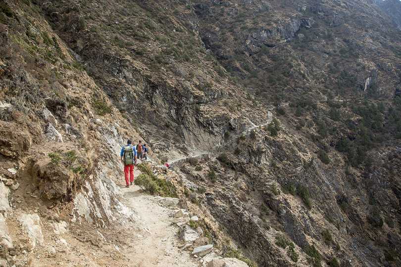 Travelers on mountainous trails of Everest Region. 